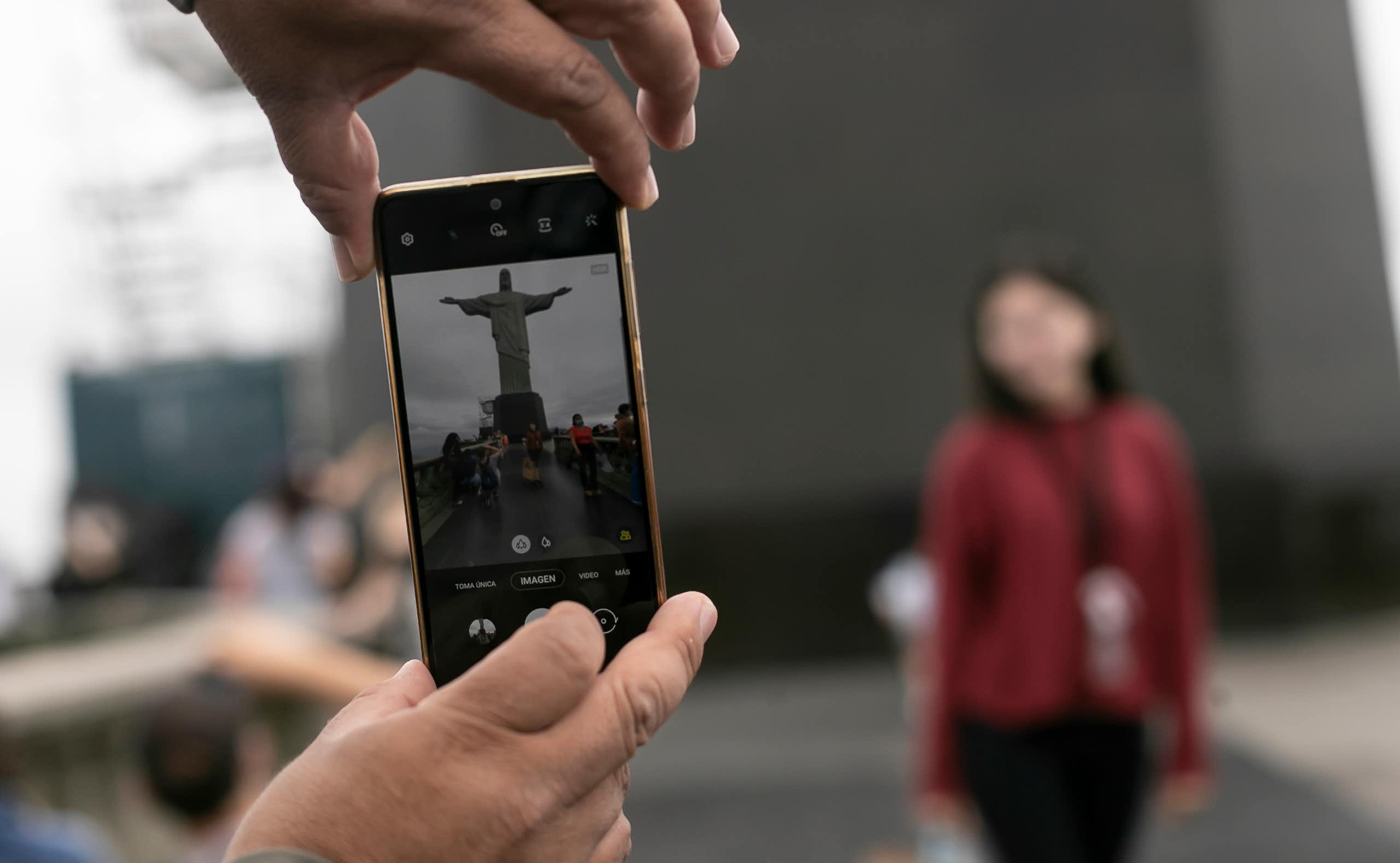 Christ the Redeemer being photographed from a mobile phone