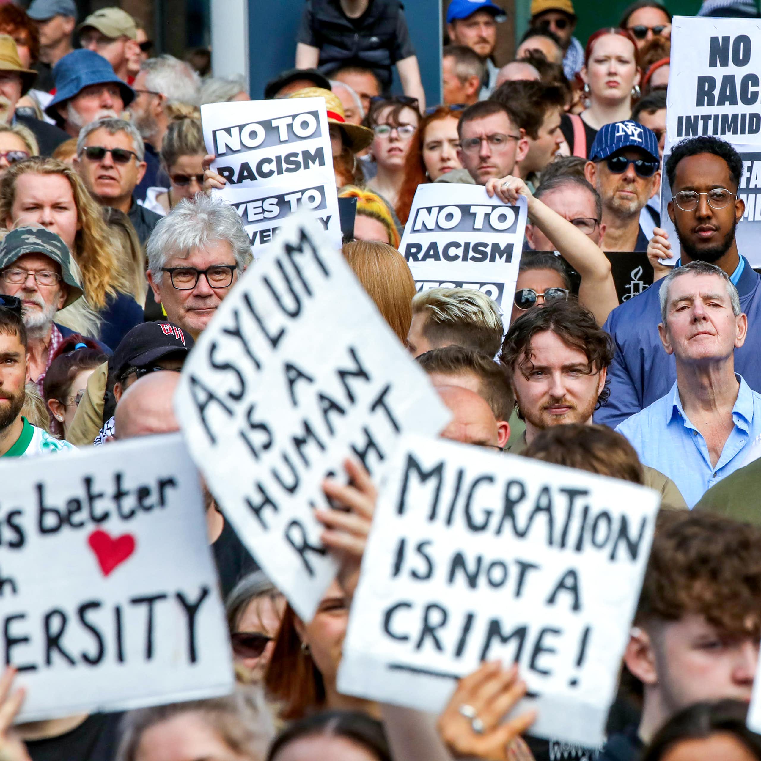 A group of people holding placards during a street protest
