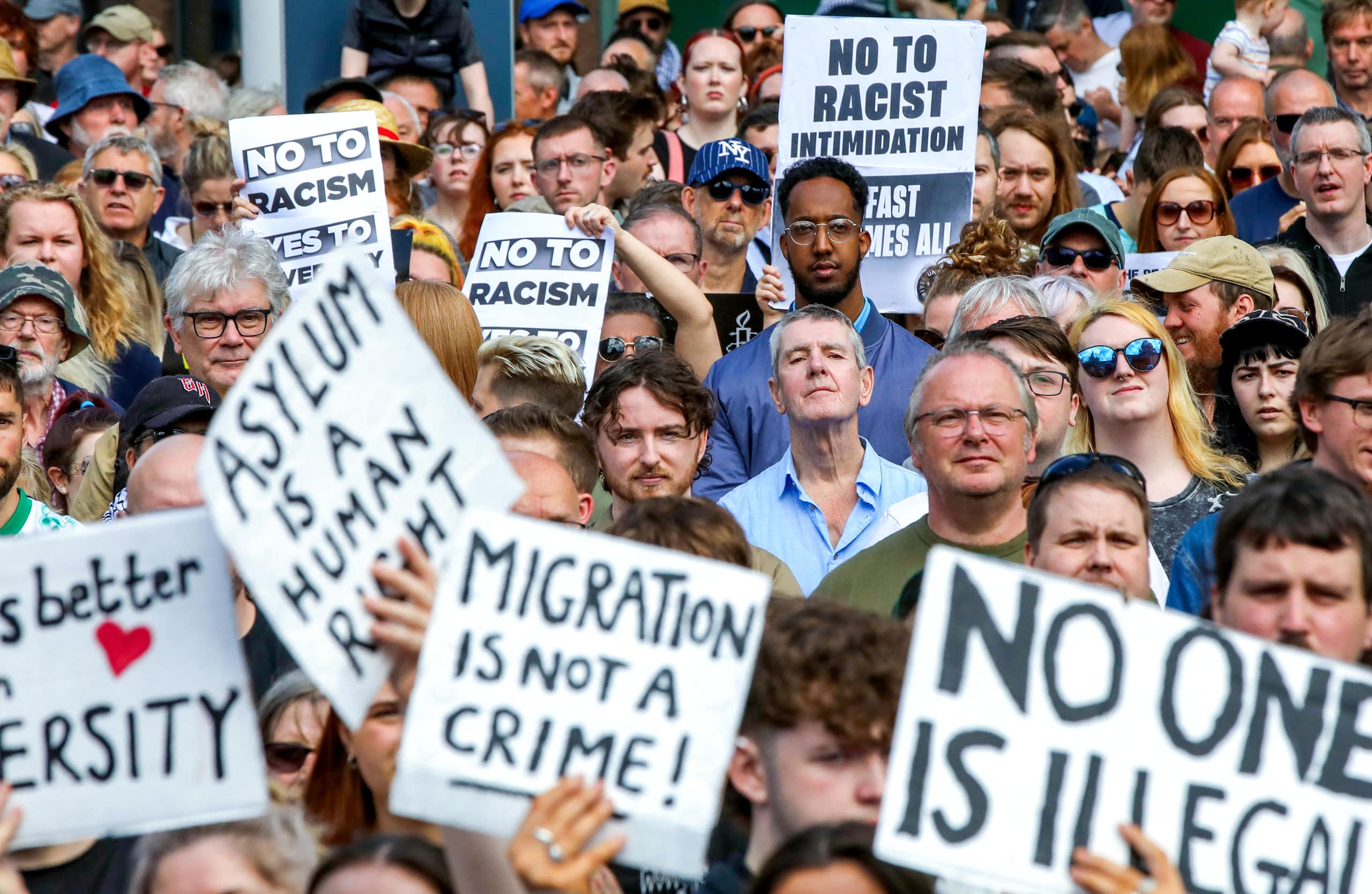 A group of people holding placards during a street protest