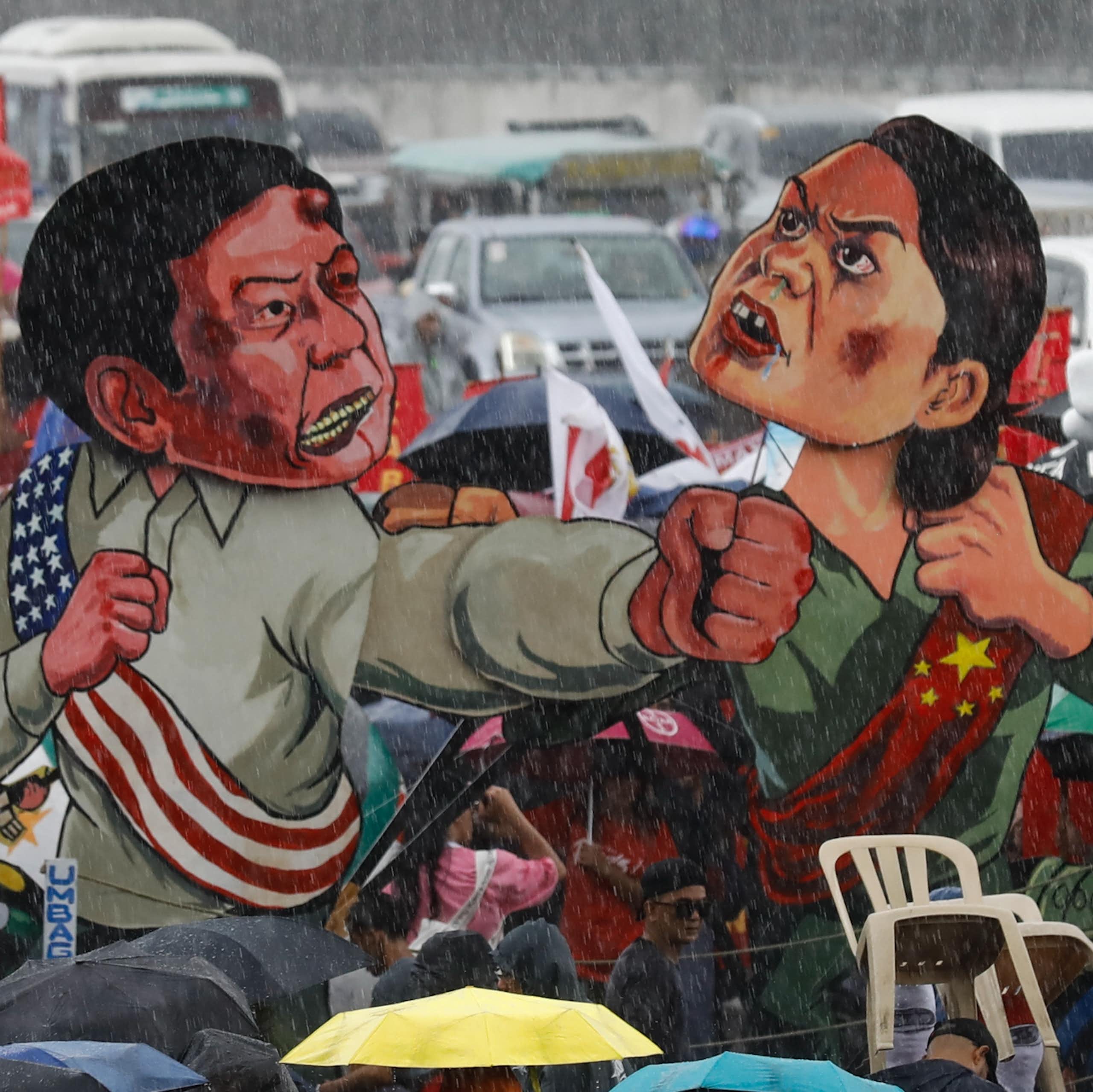 Cutouts of Ferdinand 'Bongbong' Marcos and Sara Duterte displayed during a protest in Manila, July 2024.