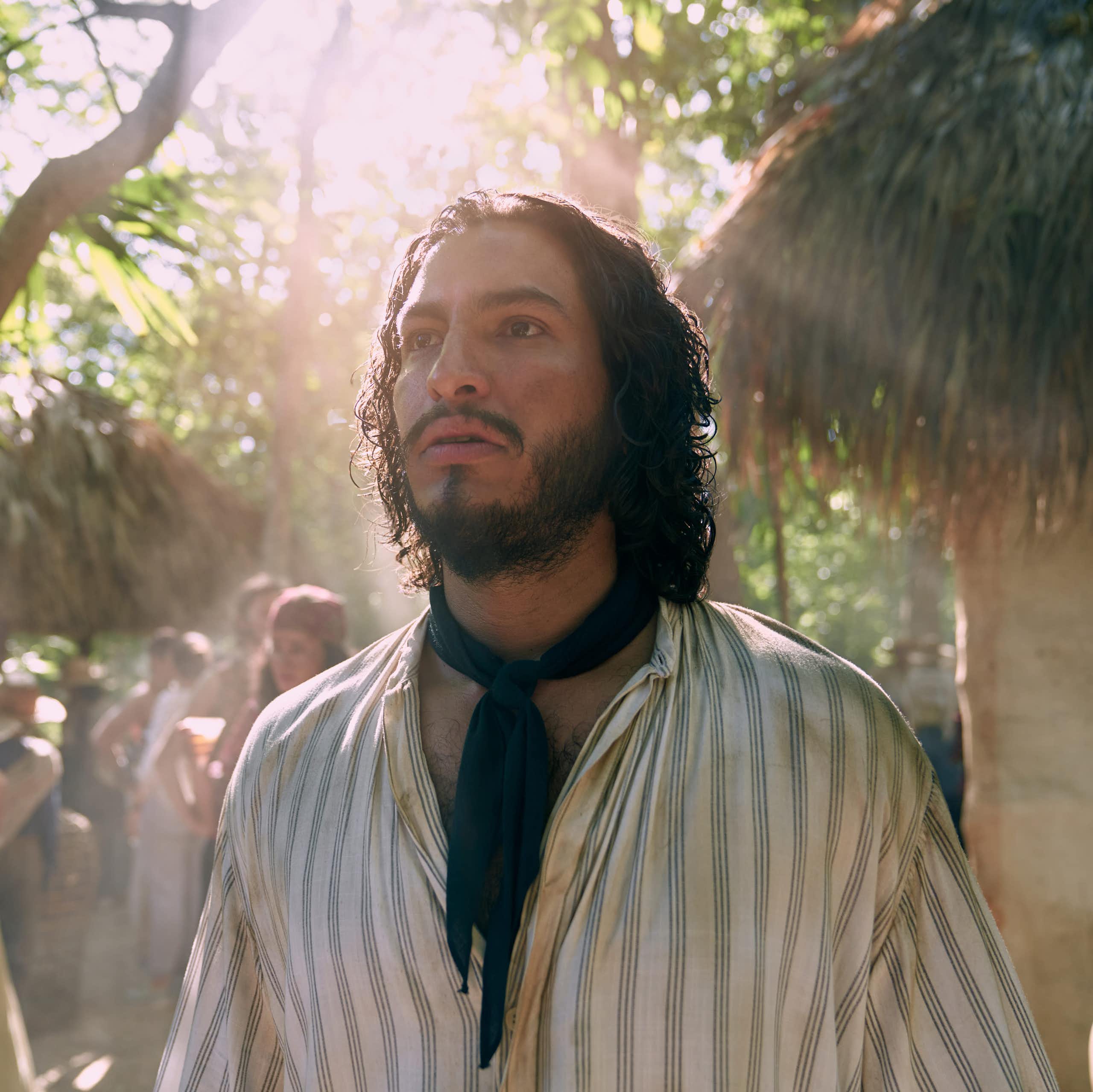 A bearded man stares into bright light as if haunted.