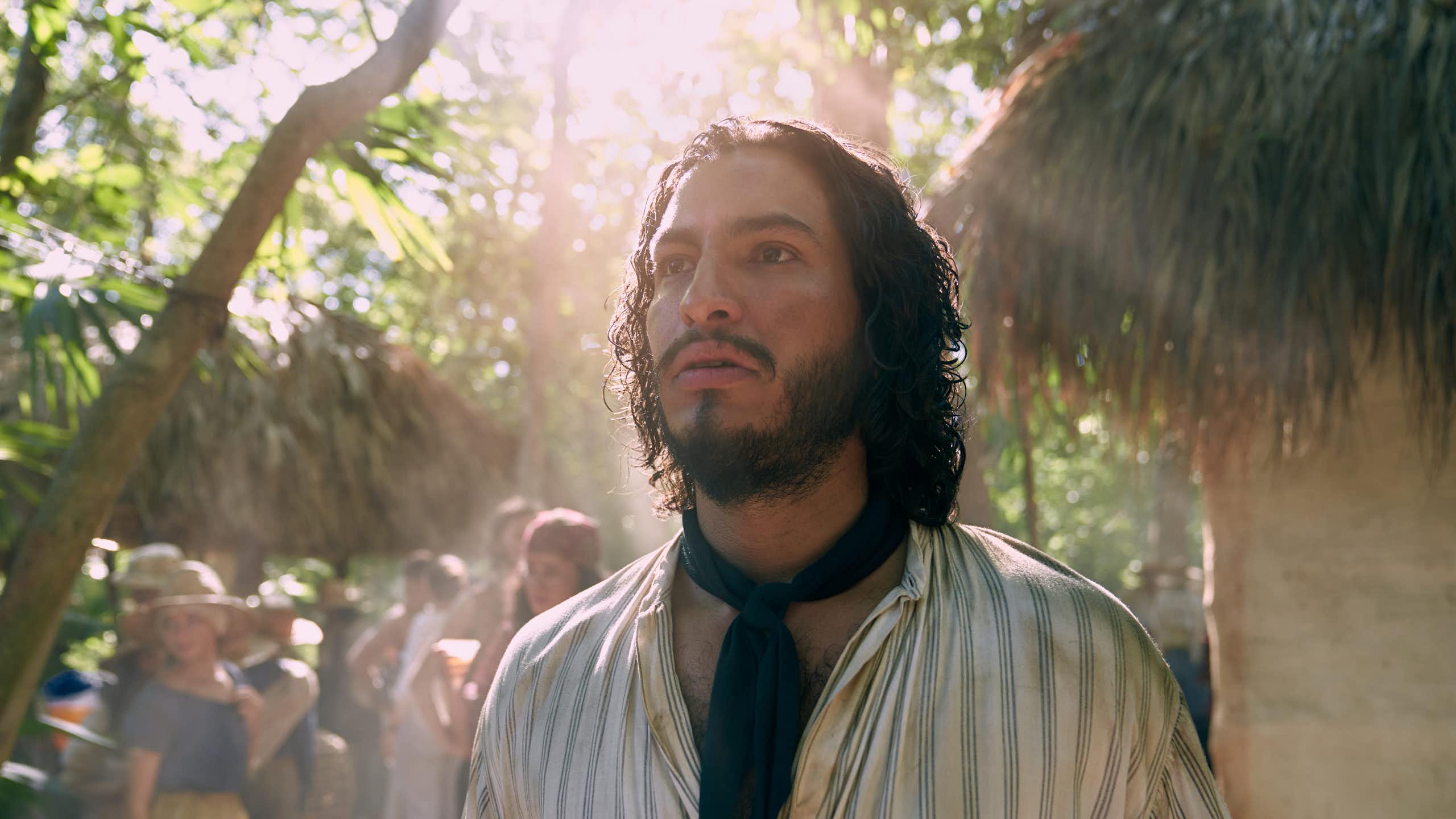 A bearded man stares into bright light as if haunted.