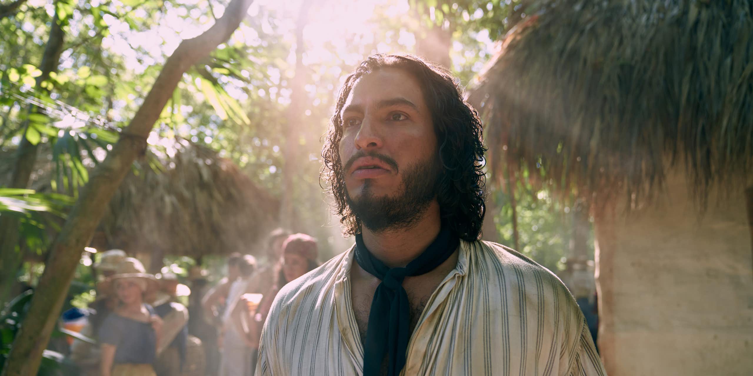 A bearded man stares into bright light as if haunted.