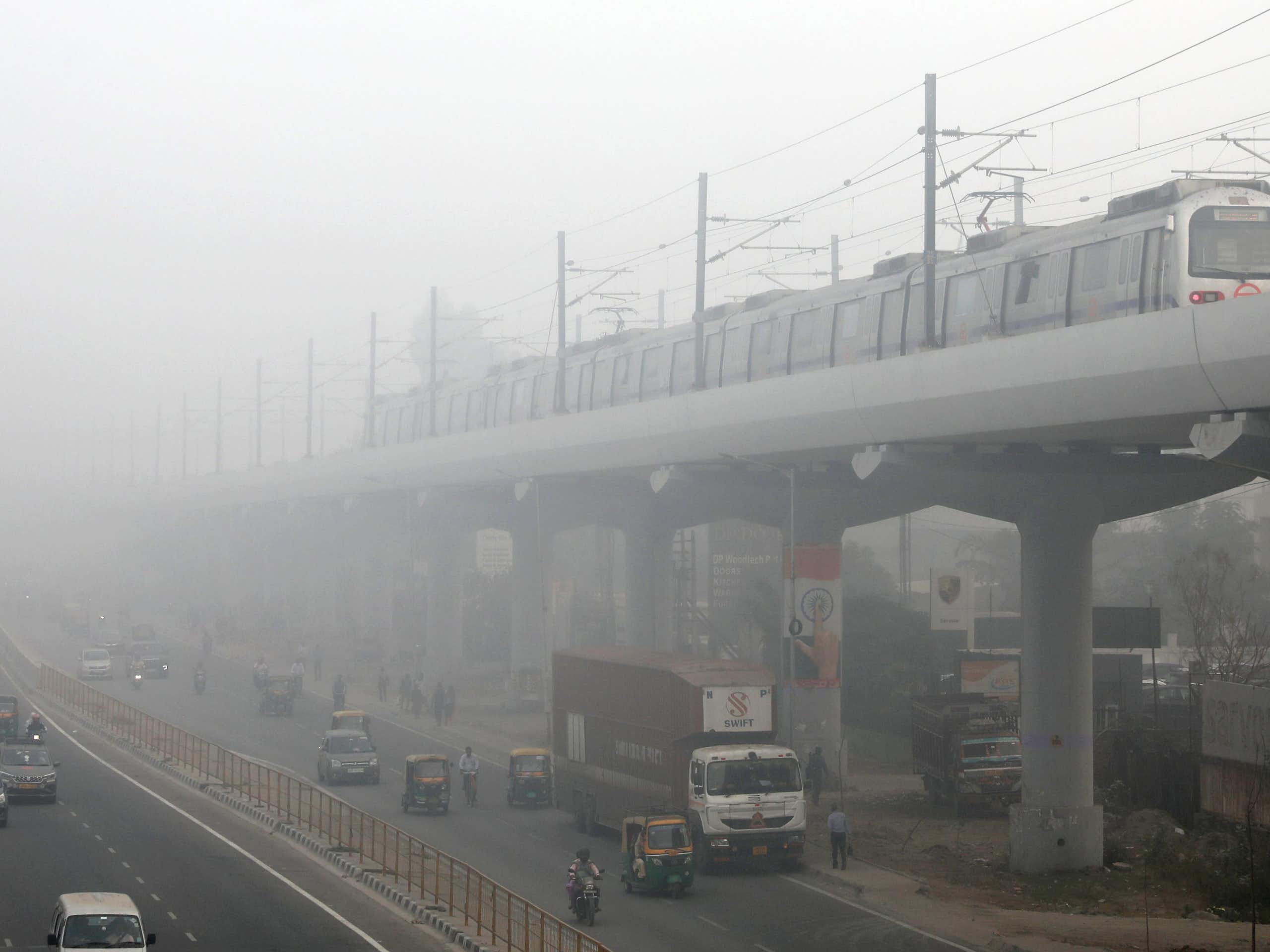Metro train on elevated track disappears into smog