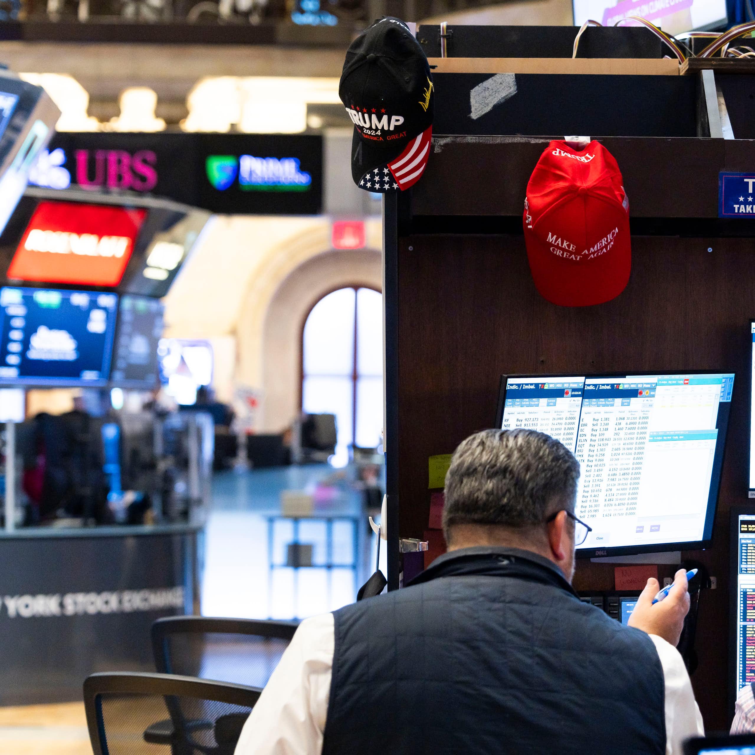 A trader with Trump merchandise hanging around his workspace on the floor of the New York Stock Exchange in New York, New York, USA, 06 November 2024.