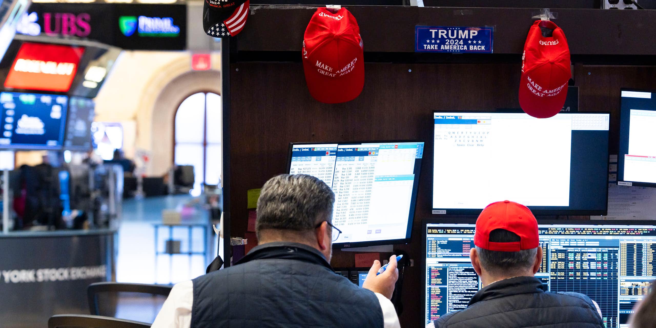 A trader with Trump merchandise hanging around his workspace on the floor of the New York Stock Exchange in New York, New York, USA, 06 November 2024.