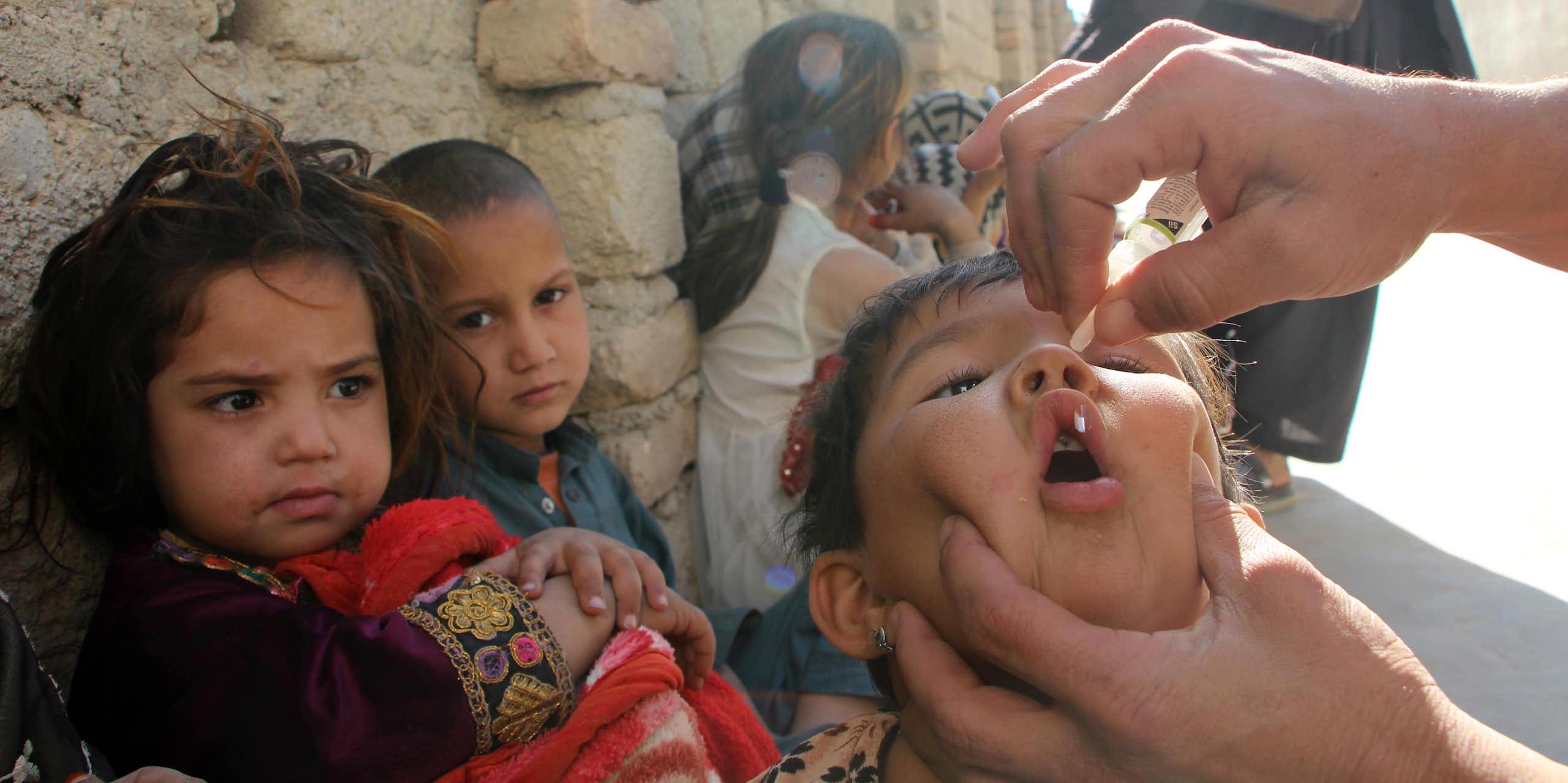 A health worker administers a polio vaccination to a child in Kandahar, Afghanistan.