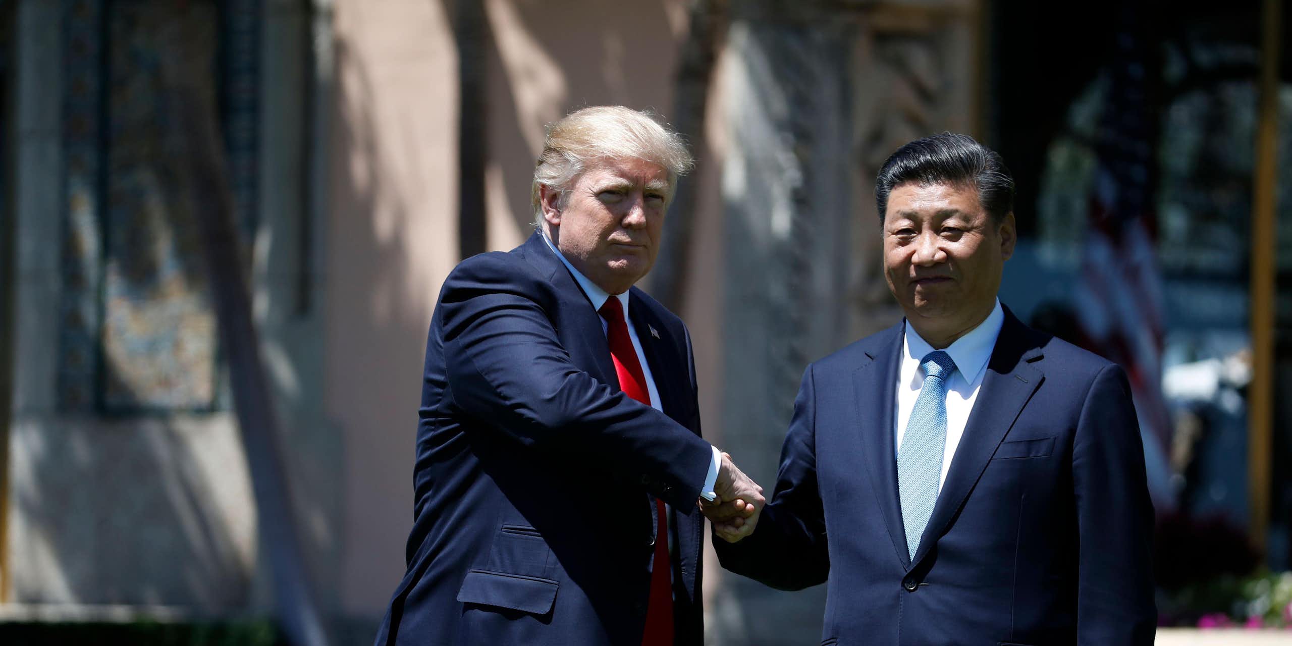 Donald Trump and Xi Jingping shake hands.