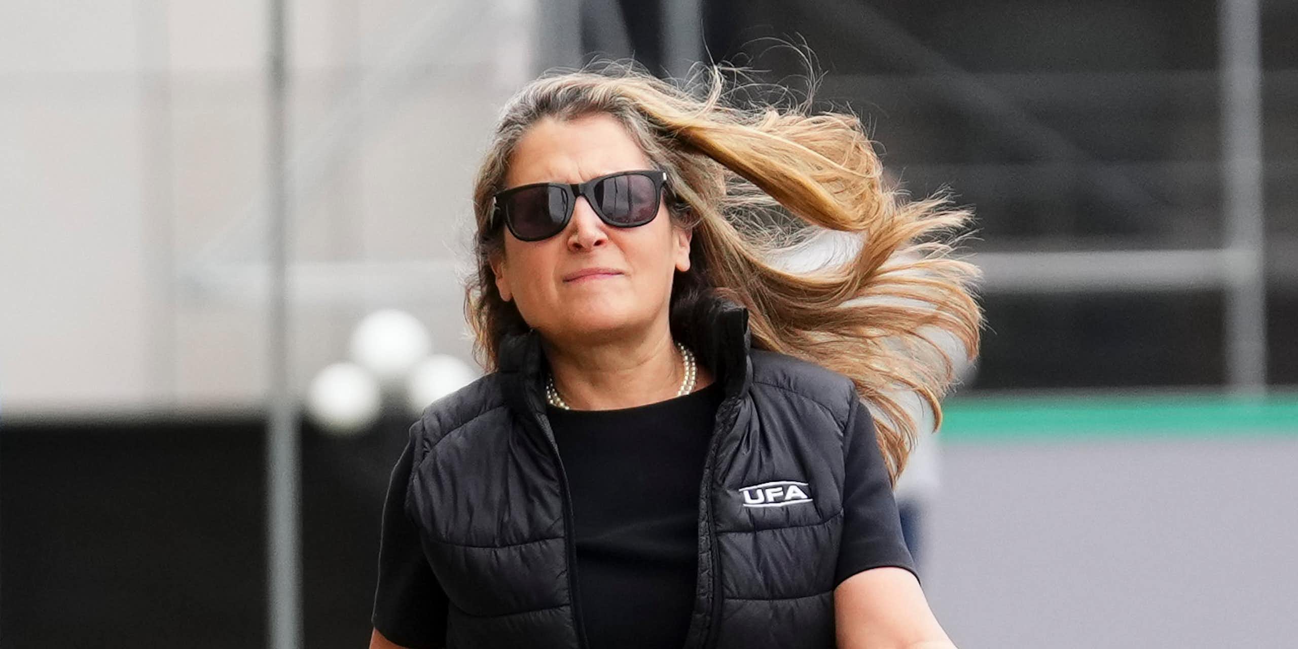 Une femme portant des lunettes marche d'un pas décidé