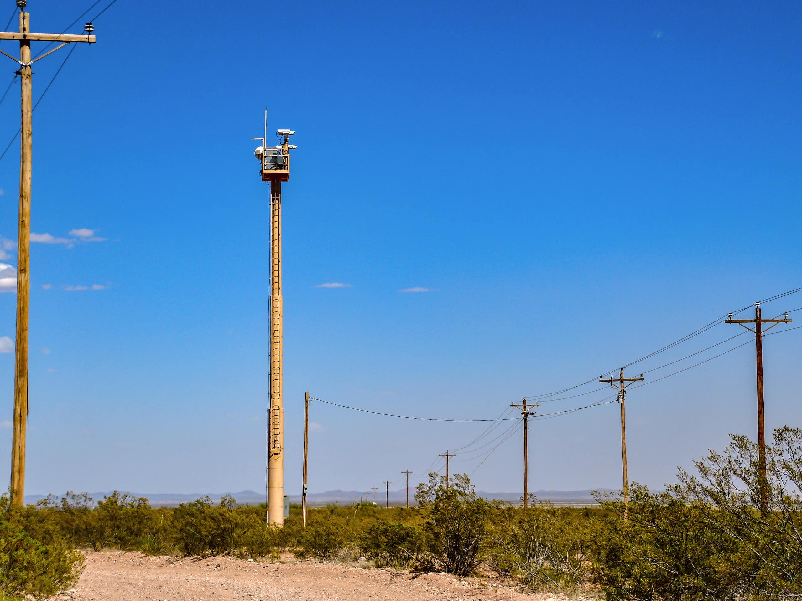 a pole with a camera mounted on top in the desert